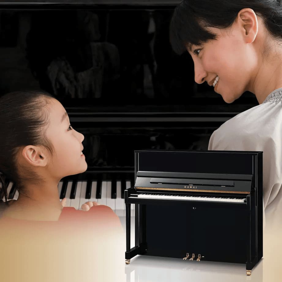 Parent teaching child piano